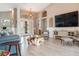 Bright, open-concept living room features a driftwood coffee table, modern decor, and seamless indoor-outdoor living at 8178 Arlewood Cir, Port Charlotte, FL 33981