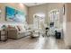 Comfortable living room with high ceilings, neutral decor, and ample natural light from shuttered windows at 8178 Arlewood Cir, Port Charlotte, FL 33981