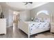 Bright main bedroom with wood flooring, tray ceiling, and ensuite bathroom with soaker tub and walk-in shower at 8178 Arlewood Cir, Port Charlotte, FL 33981