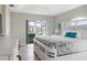Bright main bedroom with wood flooring and a view of the screened-in lanai and pool area at 8178 Arlewood Cir, Port Charlotte, FL 33981