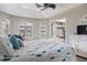 This beautiful main bedroom features wood floors, high ceilings, large windows, and access to an outdoor patio at 8178 Arlewood Cir, Port Charlotte, FL 33981