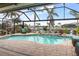 Gorgeous screened-in pool area offering serene water views and a relaxing outdoor oasis, perfect for leisure at 8178 Arlewood Cir, Port Charlotte, FL 33981