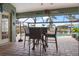 Enjoy outdoor dining on this covered pool patio with high top seating, featuring views of the pool at 8178 Arlewood Cir, Port Charlotte, FL 33981