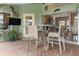This covered patio provides high-top seating and access to the indoor living space through sliding glass doors at 8178 Arlewood Cir, Port Charlotte, FL 33981