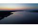 Sunset view of tranquil river, silhouetted landscape, and twilight skies create an ideal waterfront escape at 8178 Arlewood Cir, Port Charlotte, FL 33981
