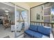 Screened-in balcony overlooking pool and lush landscaping, blending indoor and outdoor living at 915 Beach Rd # 215, Siesta Key, FL 34242