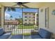 Balcony view of community pool and lush landscaping from cozy seating area at 915 Beach Rd # 215, Siesta Key, FL 34242