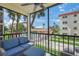Relaxing balcony with seating overlooking the pool and shuffleboard area at 915 Beach Rd # 215, Siesta Key, FL 34242