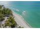 Stunning aerial view of crystal-clear ocean waters meeting a pristine sandy beach at 915 Beach Rd # 215, Siesta Key, FL 34242