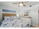 Bedroom features coastal decor, ceiling fan, and bright natural light with view at 915 Beach Rd # 215, Siesta Key, FL 34242