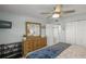 Bright bedroom with dresser, ceiling fan, and spacious closet offers comfort and functionality at 915 Beach Rd # 215, Siesta Key, FL 34242