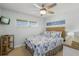 Cozy bedroom features nautical decor, a ceiling fan, and natural light from the window at 915 Beach Rd # 215, Siesta Key, FL 34242