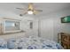 Bright bedroom has coastal decor, ceiling fan, and natural light through the window at 915 Beach Rd # 215, Siesta Key, FL 34242