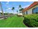 Community sign with lush landscaping and palm trees sets an inviting tone at 915 Beach Rd # 215, Siesta Key, FL 34242