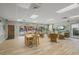 Bright community room with wood-look tile flooring, comfortable seating, dining tables, and access to the pool at 915 Beach Rd # 215, Siesta Key, FL 34242