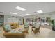 Cozy community room with rattan furniture, tables, pool access, and natural light at 915 Beach Rd # 215, Siesta Key, FL 34242