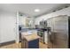 Bright kitchen with white cabinets, stainless steel appliances, butcher block island, and modern backsplash at 915 Beach Rd # 215, Siesta Key, FL 34242
