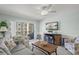 Inviting living room with a neutral color scheme and access to the balcony at 915 Beach Rd # 215, Siesta Key, FL 34242