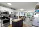 Open floor plan featuring a modern kitchen with stainless steel appliances and a cozy living area with a balcony at 915 Beach Rd # 215, Siesta Key, FL 34242