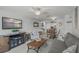 Spacious living room with entertainment center and an open layout to the dining area at 915 Beach Rd # 215, Siesta Key, FL 34242