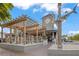 Restaurant with a shark on the building and outdoor seating with a pergola at 915 Beach Rd # 215, Siesta Key, FL 34242