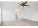 The bedroom has tile floors, a ceiling fan, and an open doorway to the ensuite bathroom at 5260 Jessamine Ave, North Port, FL 34291