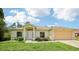 Well-maintained single-story home featuring a manicured lawn, two-car garage, and an inviting entrance at 5260 Jessamine Ave, North Port, FL 34291