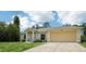 Charming single-Gathering home featuring a well-manicured lawn, two-car garage, and an inviting facade at 5260 Jessamine Ave, North Port, FL 34291