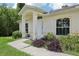 Home's entrance features a covered porch, well-maintained landscaping, and an inviting walkway at 5260 Jessamine Ave, North Port, FL 34291