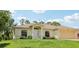 Charming single-story home featuring a manicured lawn, attached two car garage, and welcoming front entrance at 5260 Jessamine Ave, North Port, FL 34291