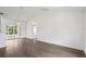 Light-filled living room showcasing wood floors, an open layout, and seamless access to the outdoor patio at 5260 Jessamine Ave, North Port, FL 34291