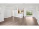 Open-concept living room with wood floors, a kitchen view, and sliding glass doors to the outside at 5260 Jessamine Ave, North Port, FL 34291