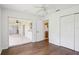 The bedroom features hardwood floors, a ceiling fan, sliding glass doors to the patio, and an ensuite bathroom at 5260 Jessamine Ave, North Port, FL 34291
