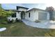 Modern single-story home with gray paver driveway and landscaping at 124 Hercules Dr, Rotonda West, FL 33947