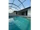 Relaxing pool area with covered lanai at 124 Hercules Dr, Rotonda West, FL 33947