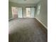Large main bedroom with gray carpeting and barn door at 124 Hercules Dr, Rotonda West, FL 33947