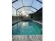 Inviting pool with covered enclosure at 124 Hercules Dr, Rotonda West, FL 33947