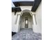 Elegant entryway with arched entry and paver walkway at 124 Hercules Dr, Rotonda West, FL 33947