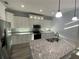 Spacious kitchen with granite countertops and stainless steel appliances at 124 Hercules Dr, Rotonda West, FL 33947