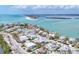 Aerial view of a coastal community with turquoise waters, sandy beaches, and beautiful waterfront estates at 10009 Gasparilla Pass Blvd, Boca Grande, FL 33921