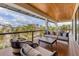 Relax on this outdoor balcony with comfortable seating and views of the surrounding tropical landscape at 10009 Gasparilla Pass Blvd, Boca Grande, FL 33921