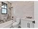 Modern bathroom with tiled walls, soaking tub, and sleek fixtures at 10009 Gasparilla Pass Blvd, Boca Grande, FL 33921