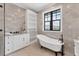 The spacious bathroom features a freestanding tub, tiled walls and floors, and a glass shower at 10009 Gasparilla Pass Blvd, Boca Grande, FL 33921