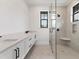 The bathroom has tile floors, a glass enclosed shower, and double sinks at 10009 Gasparilla Pass Blvd, Boca Grande, FL 33921