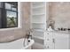 The spacious bathroom features a freestanding tub, tiled walls and floors, and a glass shower at 10009 Gasparilla Pass Blvd, Boca Grande, FL 33921