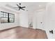 Bright bedroom features hardwood floors, a modern ceiling fan, and an ensuite bathroom at 10009 Gasparilla Pass Blvd, Boca Grande, FL 33921