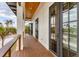 Spacious deck featuring glass paneled French doors and wood railing at 10009 Gasparilla Pass Blvd, Boca Grande, FL 33921