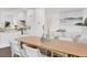 Elegant dining room featuring hardwood floors, stylish furniture, and natural light, creating a warm ambiance at 10009 Gasparilla Pass Blvd, Boca Grande, FL 33921