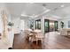 Bright dining room with large table, natural light, hardwood floors, and stylish furniture, creating a cozy ambiance at 10009 Gasparilla Pass Blvd, Boca Grande, FL 33921