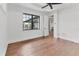 The empty room has wood floors, large windows, and neutral colors at 10009 Gasparilla Pass Blvd, Boca Grande, FL 33921